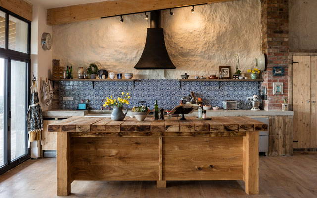 Country kitchen with black chimney-style extractor hood