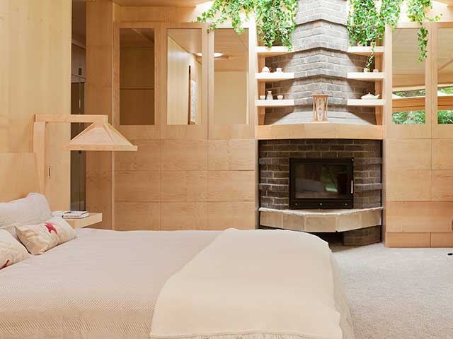 Master bedroom with open brickwork fireplace