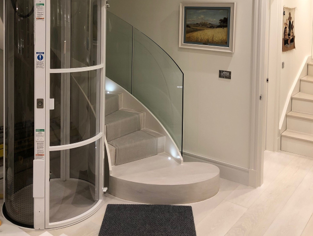 curved accessible lift next to staircase