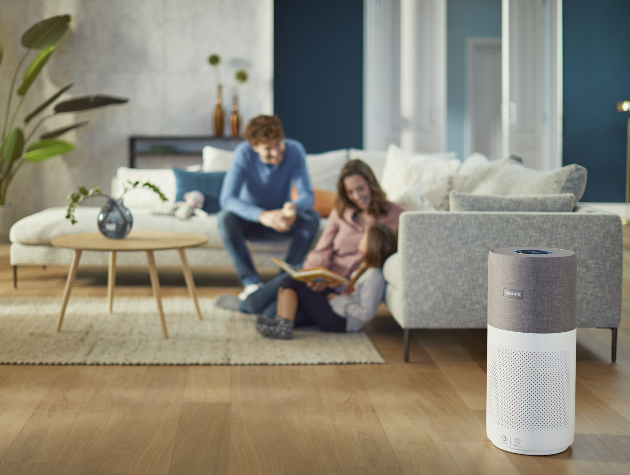 family relax in lounge air purifier in foreground