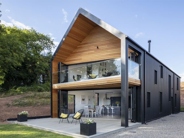 Exterior of the timber-frame self-build in Leominster with black cladding and barn-style design