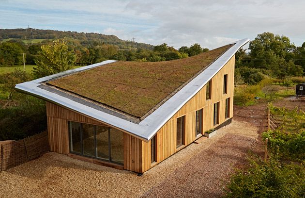 Self-build timber-frame farmhouse surrounded by rolling Devon countryside.