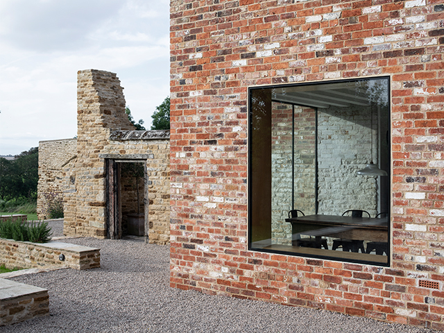 Detail of the extension walls made with reclaimed brick. The reined building walls can be seen behind the extension.