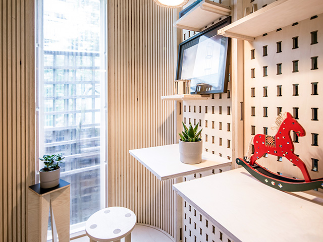 interior of garden home office pod made with prefabricated panels, including adaptable storage solutions
