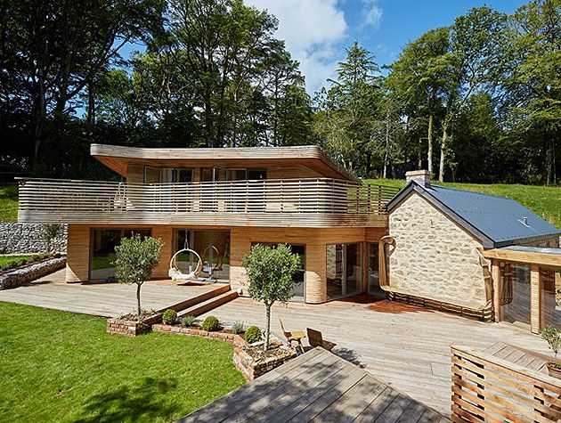 self-build timber-frame extension exterior showing link to adjacent stone cottage