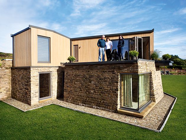Exterior of a two storey house with brick cladding on the ground floor and timber cladding to the first floor.