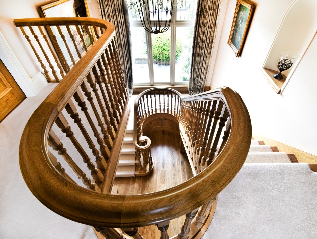 winding staircase with large window and frames