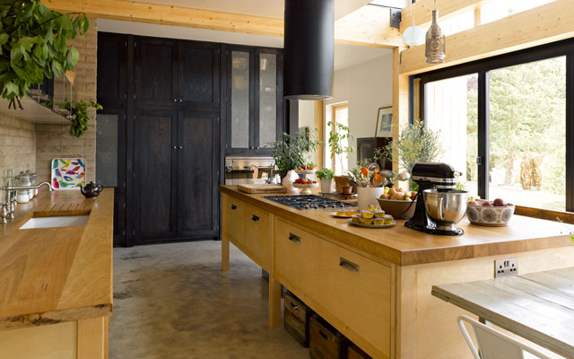 Open-plan country kitchen with timber work surfaces 