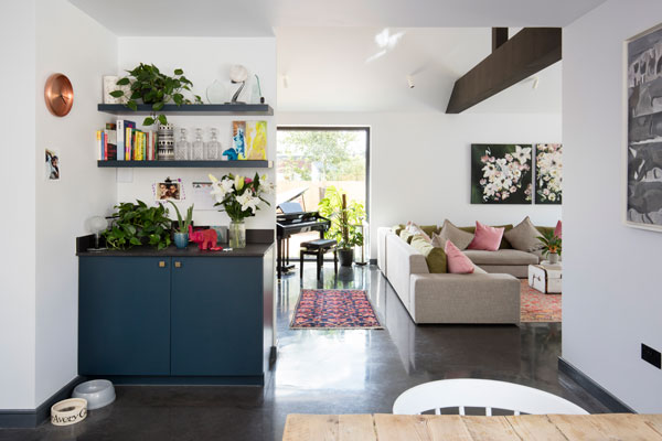 View from dining area through to the living area and kitchen in a well insulated home with double-glazed windows