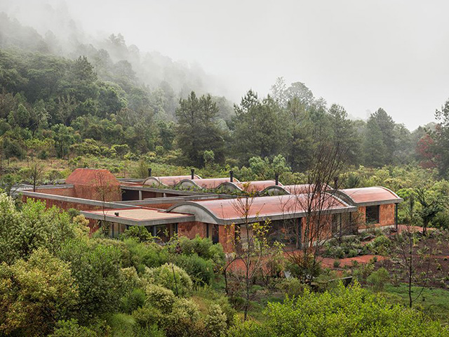 The red brick and undulating red tile roof of this courtyard house in the countryside around Mexico City.