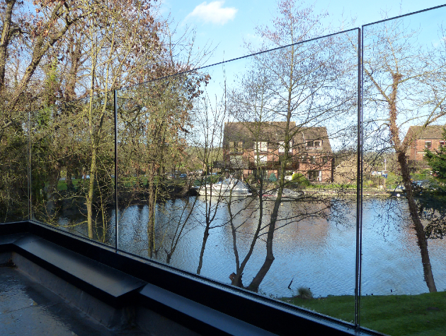 clear glass panels next to a weir 