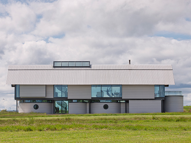The outside of the Grand Designs Stratfield Airfield building resembling aircrafters