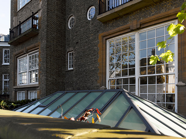 Outside the former recording studio is a residential block with large paned windows 