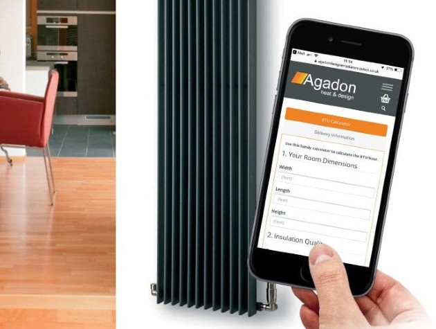 hand holding smartphone next to room with vertical radiator