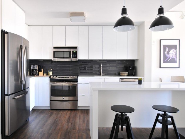 kitchen with white units island and pendant lights