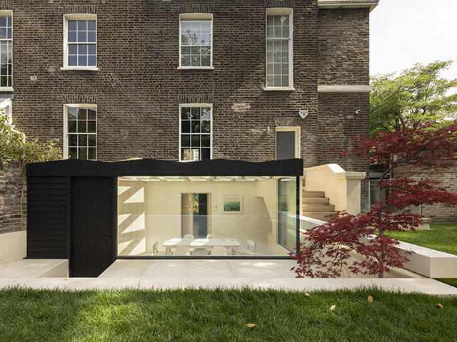 Exterior of timber frame conservatory with faceted, glazed roof 