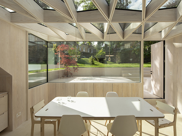 Interior of the timber frame conservatory with white washed timber panel walls