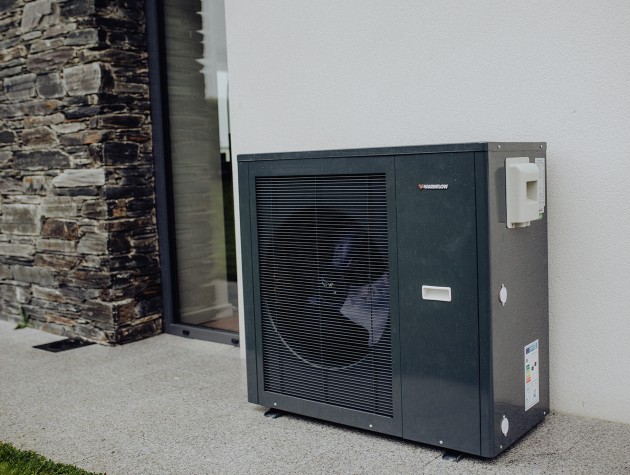 black heat pump outside a home