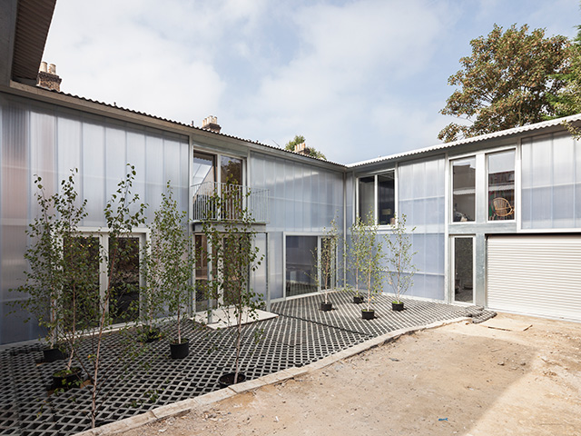Rodeca cladding covers the house while plants litter the courtyard at the centre of the Urban Shed