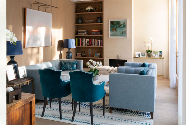 Looking into the living room of the Grand Designs graveyard house with upholstery in different shades of blue