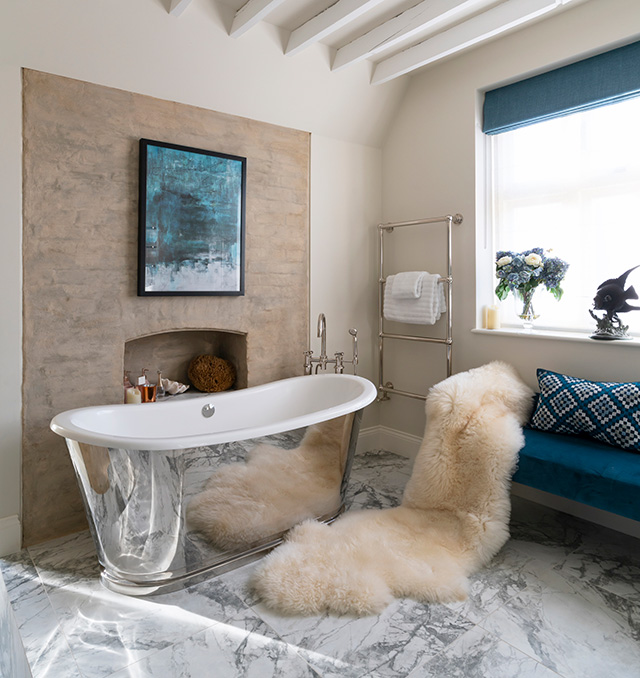 Interior design secrets of the ensuite bathroom that includes a nickel freestanding bath