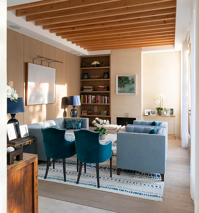 Interior design secrets in the living room include the pale and dark blue sofas and chairs