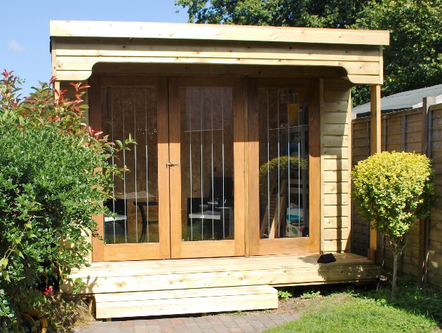 timber summer house set in garden