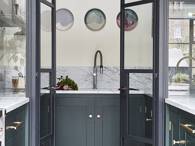 Blue utility room with sink and clear glass doors