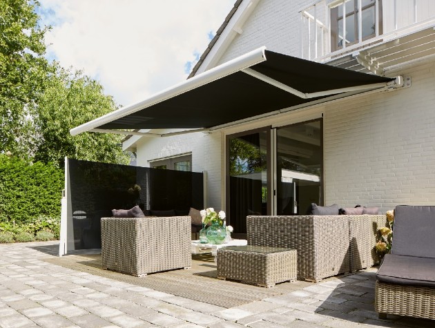 Patio with rattan garden furniture and awning
