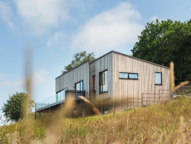 contemporary timber clad house on a sloping hillside