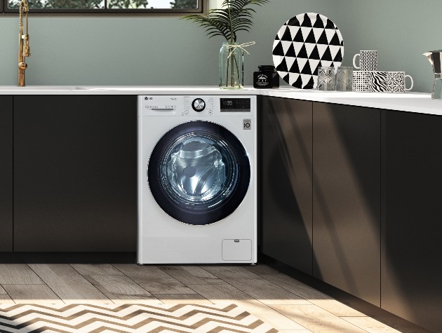 interior of kitchen with black units green walls and LG Turbowash 360 F6V1009WTSE 9kg washing machine