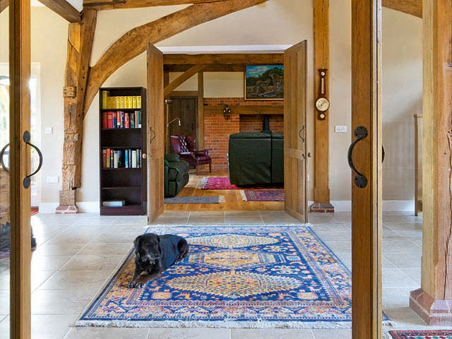 The entrance hall with patterned rug, Tudor beams and a spacious area from Grand Designs TV House, Stowmarket 2010, granddesignsmagazine.com