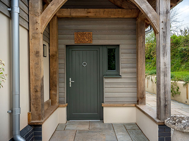 Grey panelled front door with chrome fittings in a traditional-style house