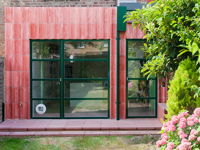 Pigmented concrete blocks clad the exterior of this kitchen extension. Image credit: Megan Taylor