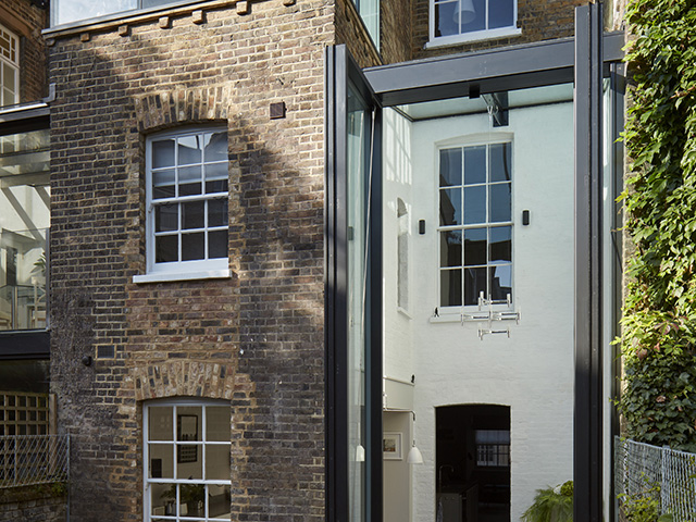 Rear exterior of a Georgian house that has been updated with a two-storey modern extension