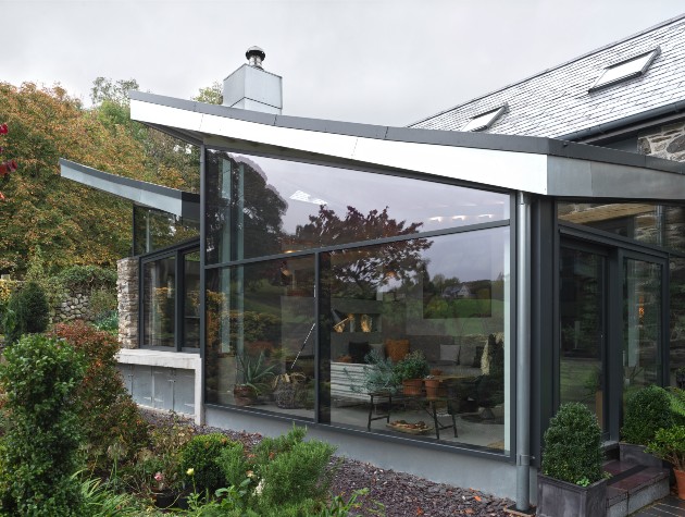 close up of extension with pitched roof and full height Shüco aluminium sliding doors