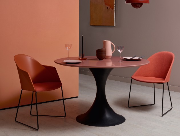 modern circular table with pair of chairs in colour matched room