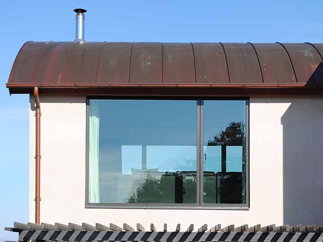 A curved roof covered in copper panels