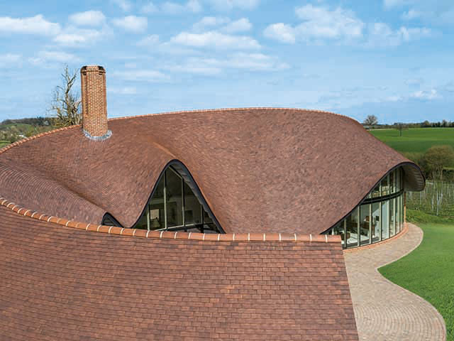 View of roof with red clay tiles as part of roofing materials guide