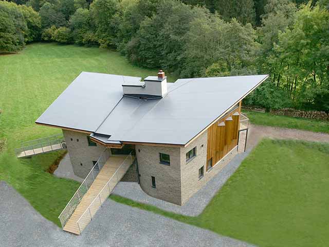 Overhead shot of a house with winged pitch roof fitted with a single ply membrane