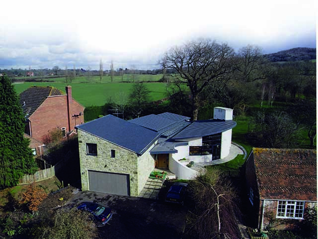 Distance overhead view of a mono-pitch roof with black membrane covering