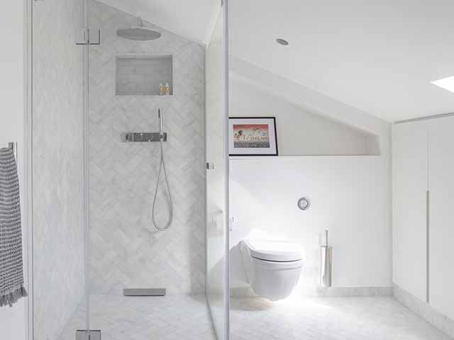 Architecture for London designed shower room with white herringbone wall tiles
