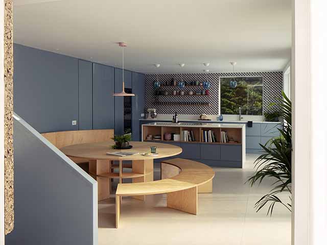 A Victorian cottage kitchen that's been renovated with a bespoke circular dining table and fitted cabinets