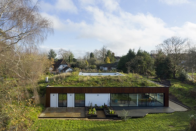 Exterior view of the house showing the turf roof, glazed sliding doors and internal courtyard
