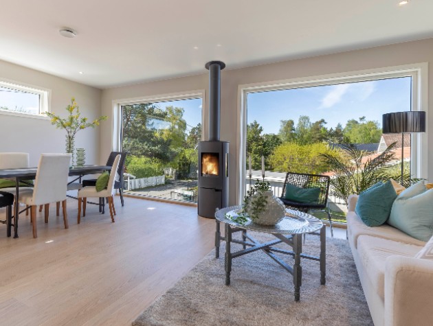living room with sofa table dining table and large windows with view