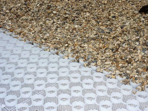 A gravel mesh system half covered with gravel by Beauxfort