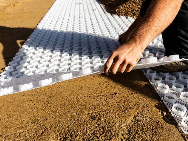 Laying a gravel grid mesh system on driveway