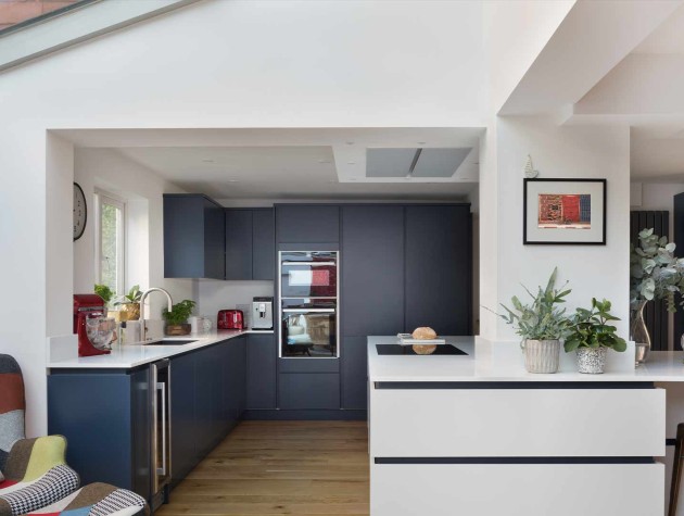 Kitchen diner extension with Masterclass Kitchens blue peripheral handleless units and white units around the structural beam