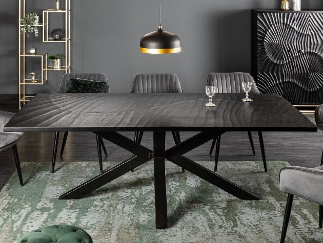 black wood table with pattern chairs and matching cabinet in background