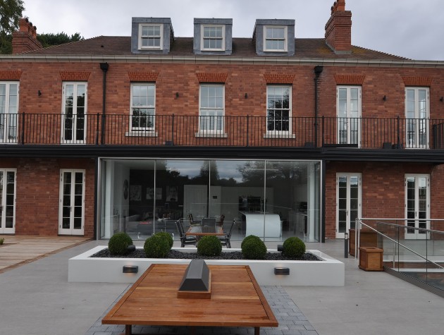 brick house with large patio doors and outdoor seating area